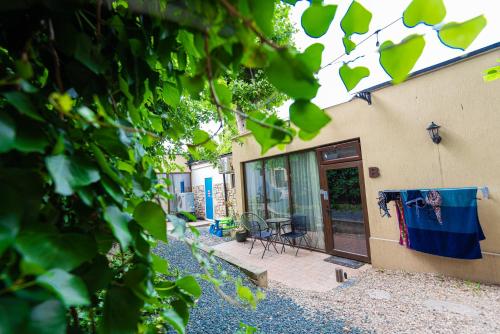 a house with a door and a chair on a patio at iVAVev IS US ByTheSea EforieSud in Eforie Sud