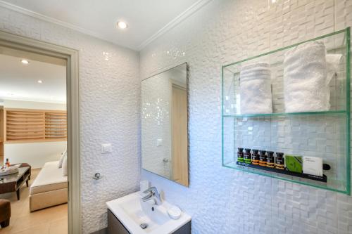 a bathroom with a sink and a mirror at KEOS by the sea in Korissia