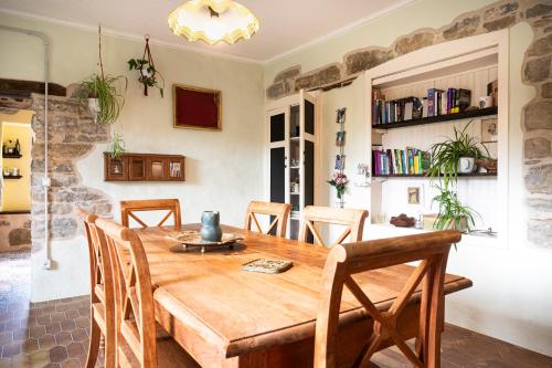 a dining room with a wooden table and chairs at Casa Luna in Monesiglio