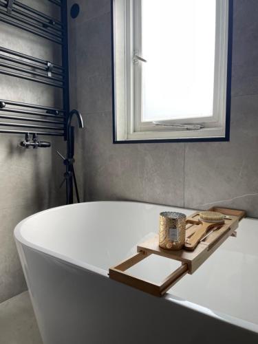 a bath tub in a bathroom with a window at Home with free parking near Amsterdam 45 min away! in Lelystad