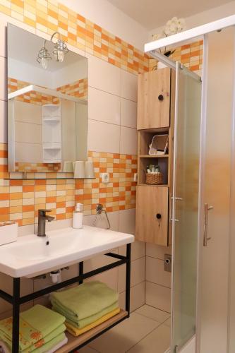 a bathroom with a sink and a shower at Apartments Panda in Bol