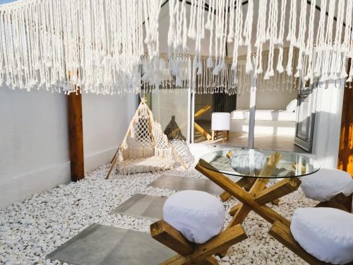 a dining room with a glass table and chairs at Meteora Superior Collection Villas II in Kalabaka