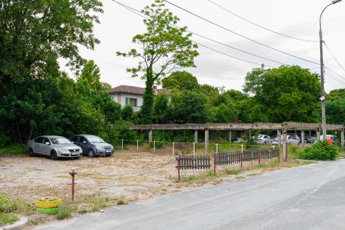 two cars parked in a parking lot next to a road at iVAVev IS US ByTheSea EforieSud in Eforie Sud
