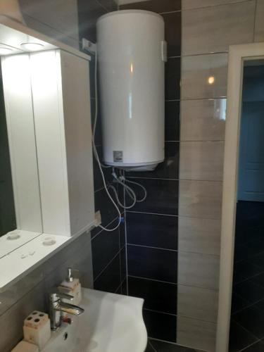 a bathroom with a white sink and a mirror at Medina in Sarajevo