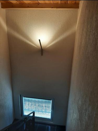a clock on the ceiling of a room with a window at Medina in Sarajevo