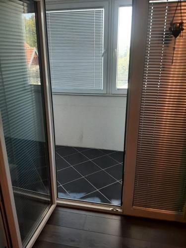 a sliding glass door in a room with a window at Medina in Sarajevo