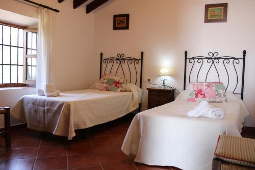 En eller flere senge i et værelse på Casa Rural Bellavista