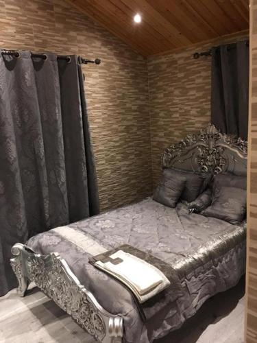 a bedroom with a silver bed in a room at Ghazalle oasis Hotel GB in El Biar