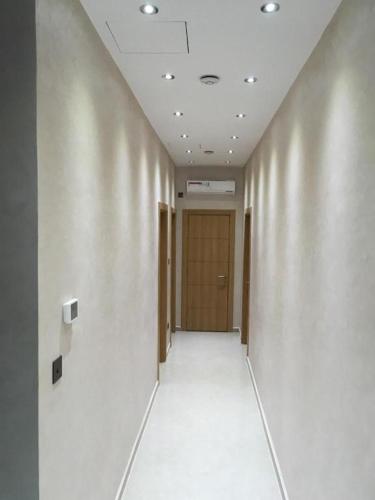 an empty hallway with a door in a building at Ghazalle oasis Hotel GB in El Biar