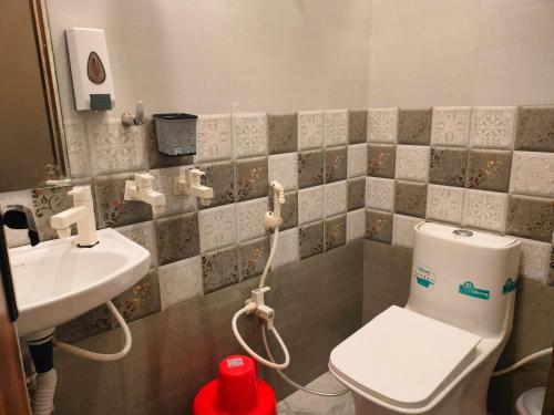 a bathroom with a toilet and a sink at Kishan Home Stay in Mathura