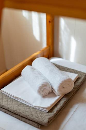 two rolled towels sitting on a plate on a table at Ionian Cape seaside apartment in Vráchos