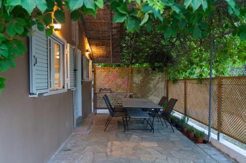 a table and chairs sitting on a patio at Ionian Cape seaside apartment in Vráchos