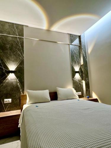 a bedroom with a large bed with a rainbow above it at Siel Residences in Perea