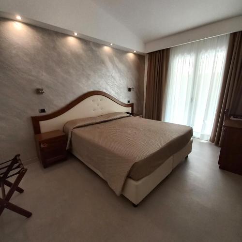 a bedroom with a large bed in a room at Hotel Nicoletta in Santa Maria Navarrese