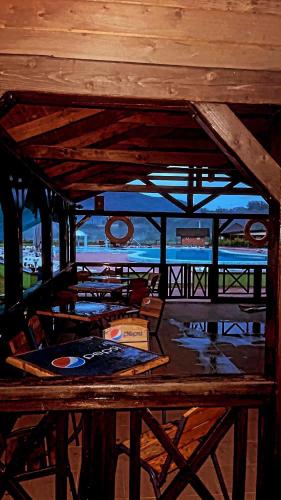 a wooden table with a view of the ocean at Moonglade Allure Houses in Polyana