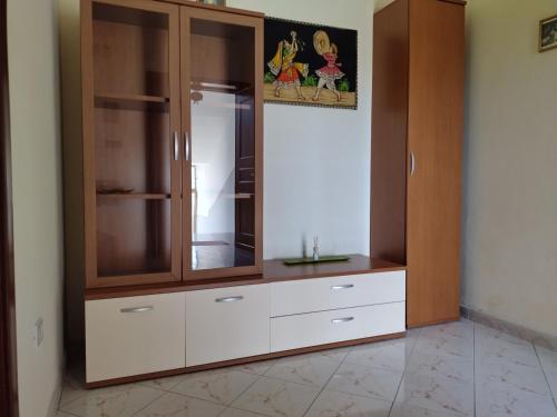 a closet with white drawers and a wooden cabinet at Nunzia Home - Appartamento indipendente 85 mq - Bagno Privato - Aria Condizionata in Baiano