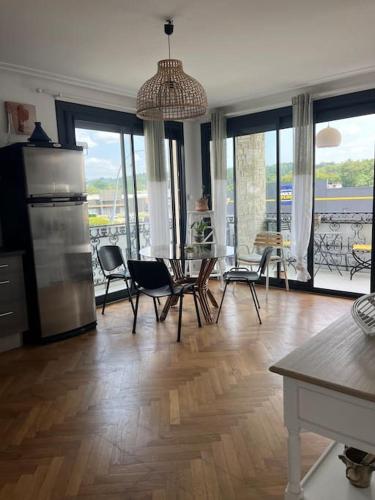 Il comprend une cuisine et un salon avec des chaises et une table. dans l'établissement Bright apartment, à Malemort-sur-Corrèze