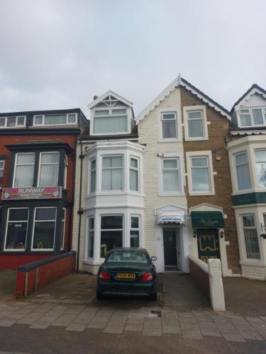 a car parked in front of a row of houses at Witton house in Blackpool