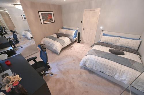 a bedroom with two beds and a mirror in it at 3 Bedroom House in Euston, Patio & BBQ in London