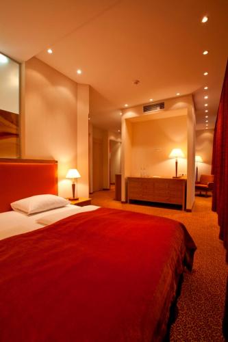 a hotel room with a bed and a large mirror at Amber SPA Boutique Hotel in Jūrmala