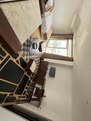 an attic room with a staircase and a window at nKAaSA hotel Personal Suites in Raxaul