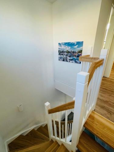 a staircase in a house with a picture on the wall at Timmendorfer Herz in Timmendorfer Strand