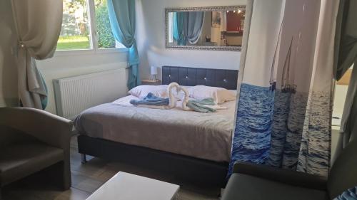 a bedroom with a bed with towels on it at chez moumie studio meublée in Bevaix