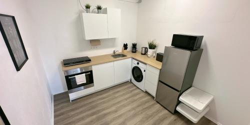 a small kitchen with a sink and a refrigerator at Monteurunterkunft Komfort Plus in Hörstel