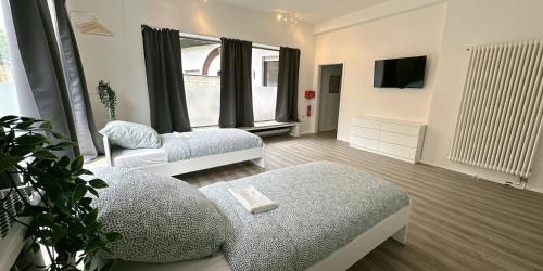 a living room with two beds and a tv at Monteurunterkunft Komfort Plus in Hörstel