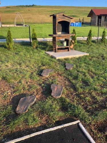 a park with a playground with rocks in the grass at Tošine Brvnare, Zlatibor, Smiljanski Zakosi in Krajevi