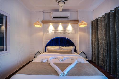 a bedroom with a bed with a heart made out of towels at The Neeraj Ganga Cottages in Rishīkesh