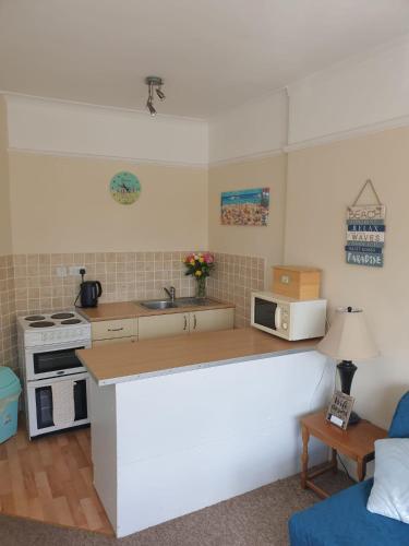 a kitchen with a counter top and a stove at San Remo in Paignton