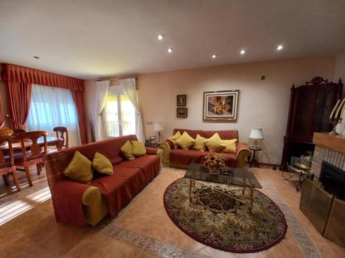 a living room with a couch and a table at Casa Rural El Raso in Almoguera