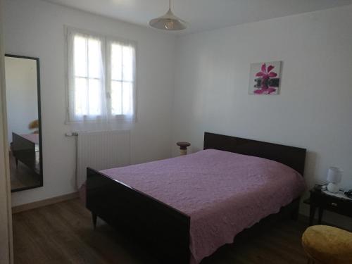- une chambre avec un lit et une couverture violette dans l'établissement Plage et tranquilité, à Saint-Brévin-les-Pins