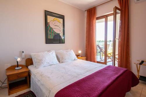 a bedroom with a large bed and a balcony at Splendid Ap PROMENADE 2 pers in Umag