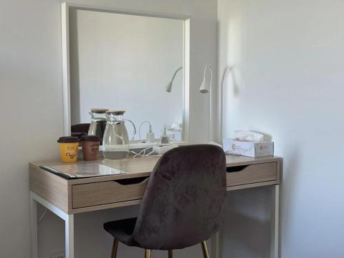 a desk with a chair in front of a mirror at Comfy Room near Metro & Airport in Lisbon