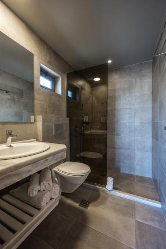 a bathroom with a sink and a toilet and a shower at Stella Village Seaside Hotel in Hersonissos
