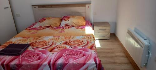 a bedroom with a bed with roses on it at Sea Wave House in Constanţa