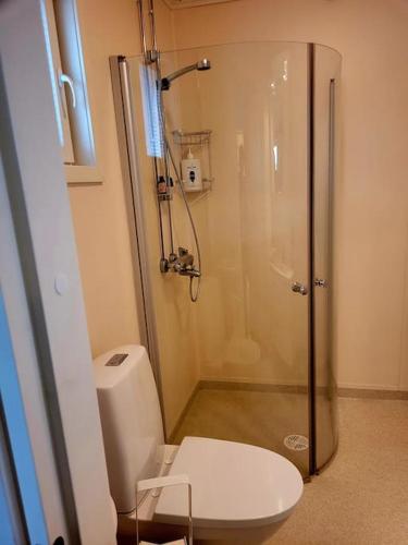 a bathroom with a shower and a toilet at Rantatalo in Pori