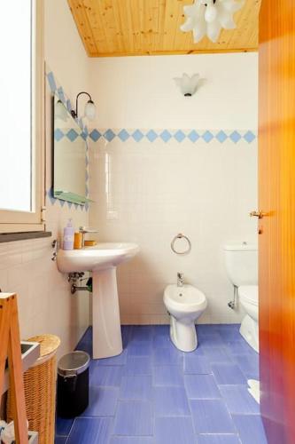 a bathroom with a sink and a toilet at Casa della Zagara in Acireale