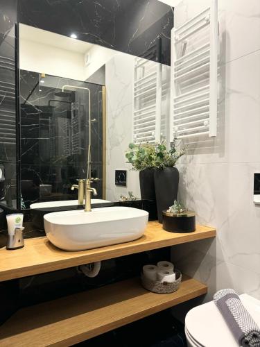 a bathroom with a white sink and a mirror at R&G luxury accommodation Varkiza in Vari