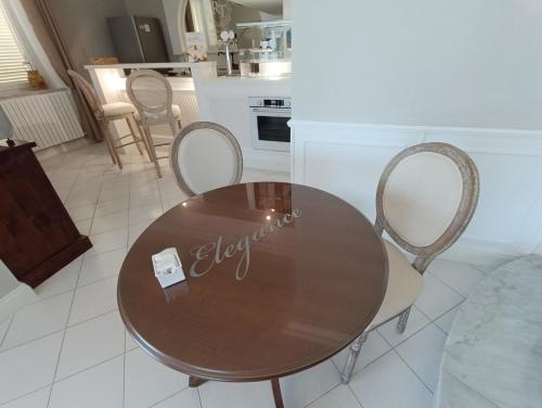 a wooden table and chairs in a kitchen at Relais Tiaré Bed and Breakfast in Bacoli
