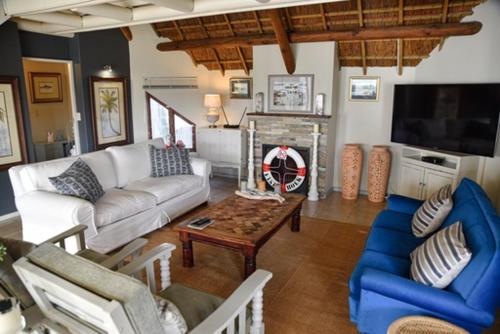 a living room with a couch and a table at Riverview in Stilbaai