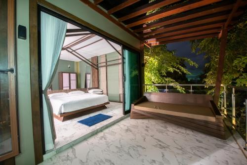 a bedroom with a bed and a large window at Ao Cho Grandview Hideaway Resort in Ko Samed
