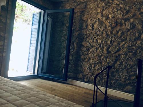 a room with a stone wall with a window at Lagada-Chios in Lagkáda