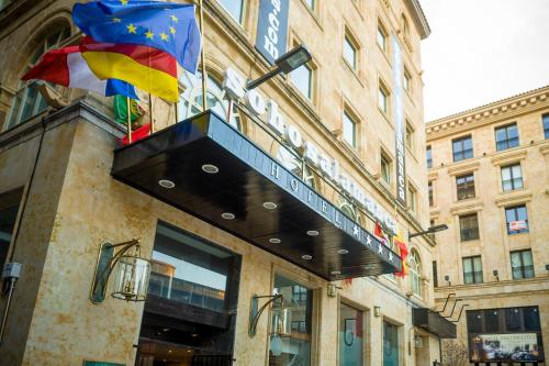 a building with a flag and a sign on it at Soho Boutique Salamanca in Salamanca