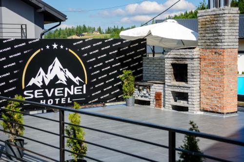 a sign for a hotel on the side of a balcony at Севеней Готель in Bukovel