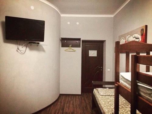a room with a flat screen tv on a wall at Hostel Serge in Lviv