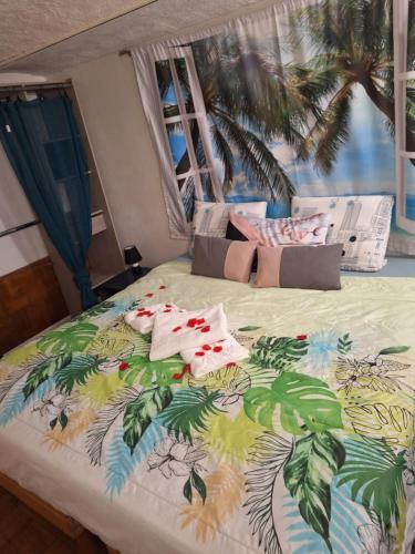 a bedroom with a bed with a tropical themed bedspread at Pitchoun in Grasse