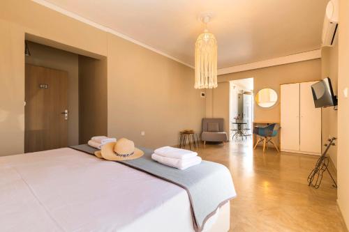 a bedroom with a bed with a hat on it at Lefka Hotel & Apartments in Rhodes Town